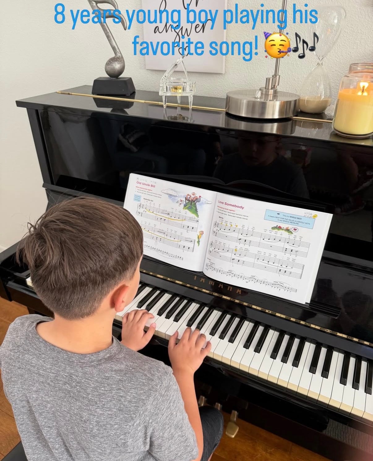 Eight-year-old piano student practicing his favorite song