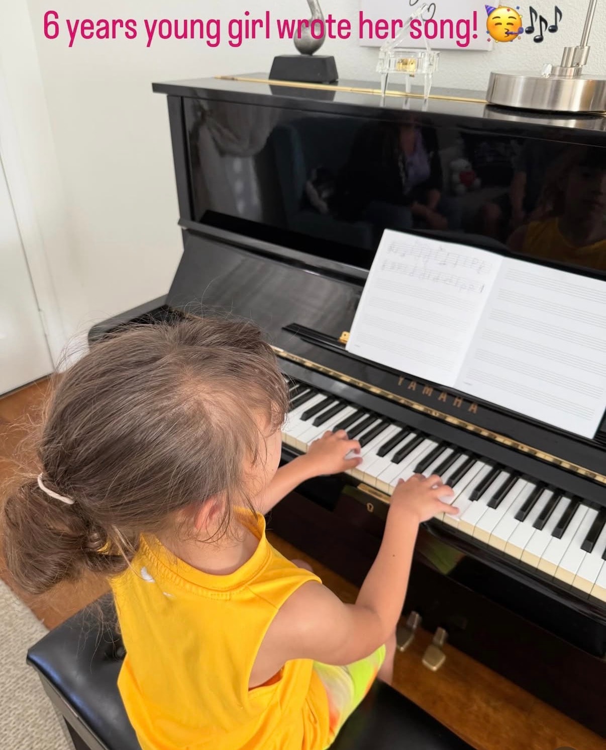 Six-year-old piano student creating her own song